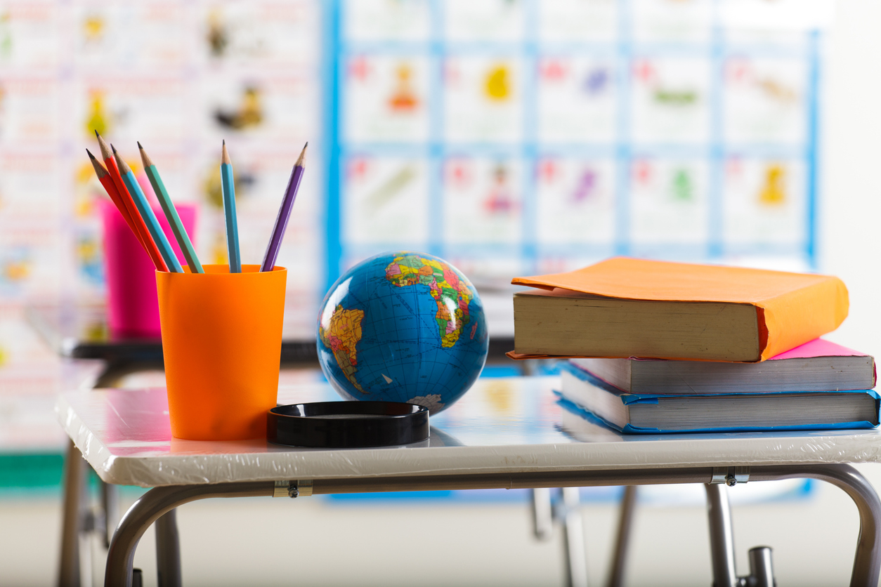Elementary School with Cup of Pencils and Globe on Desk