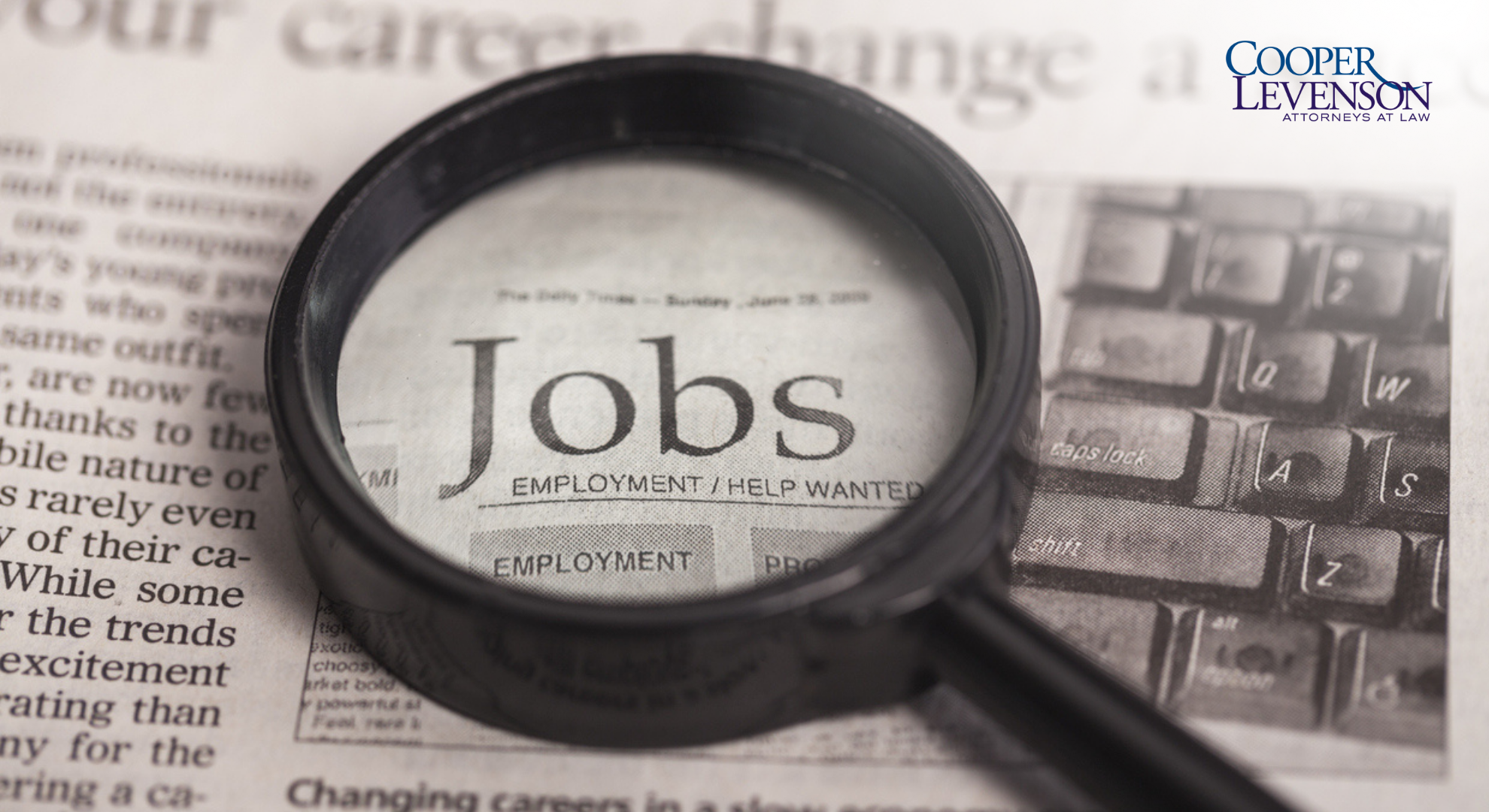 Magnifying glass on top of newspaper job ads