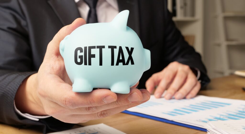 Piggy bank that says Gift Tax with tax documents on the table