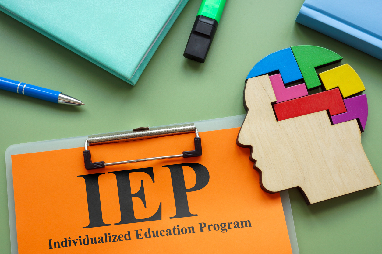 IEP - Individualized Education Program words on clipboard with brain puzzle graphic