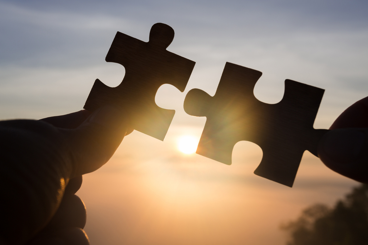 two puzzle pieces coming together