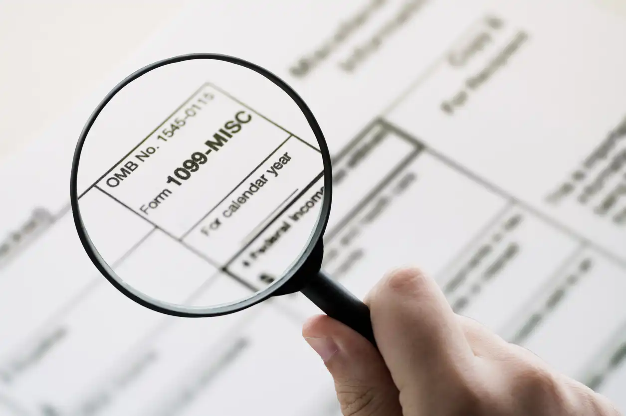magnifying glass on top of a 1099 document.